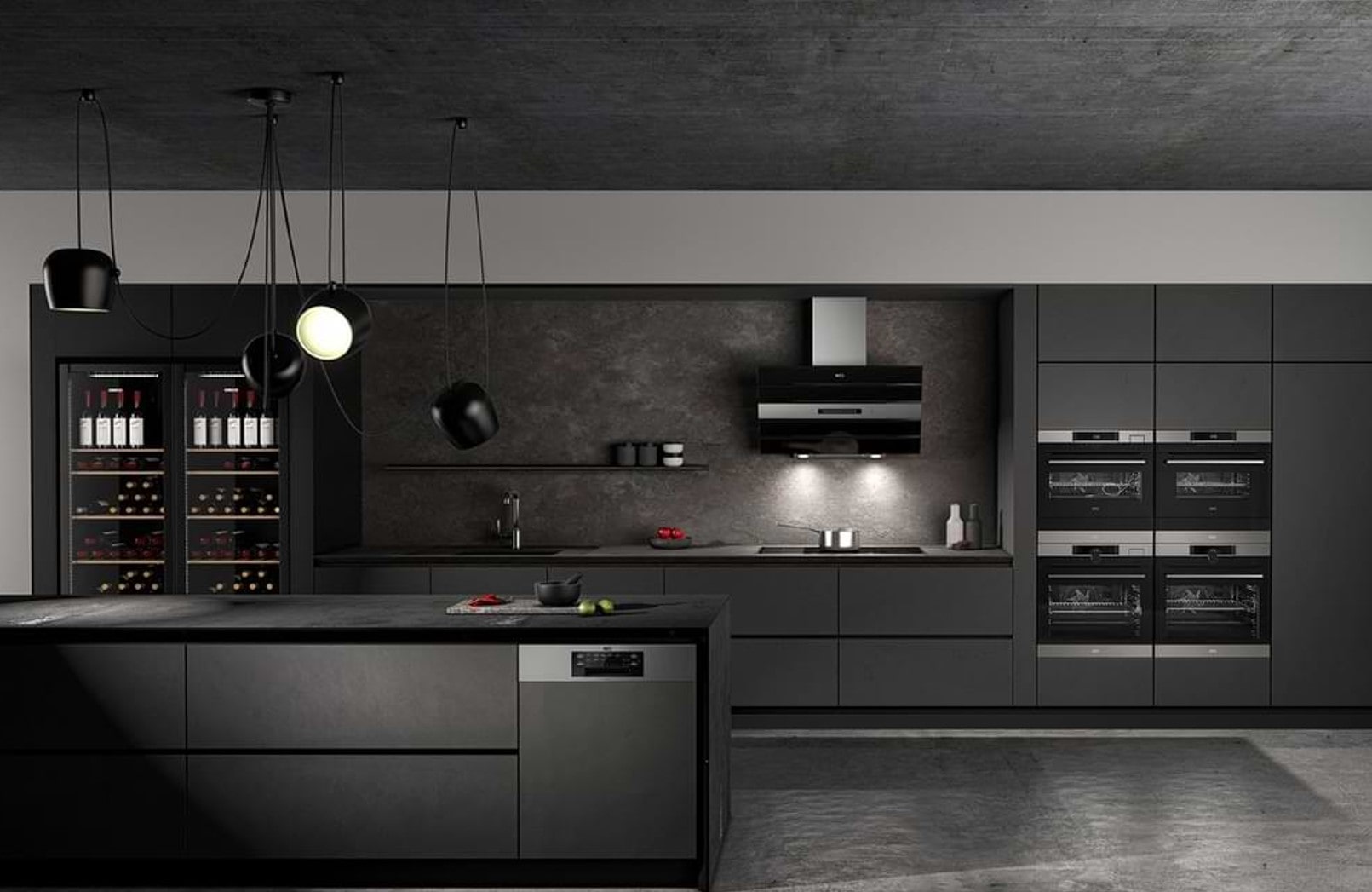 A very modern kitchen with all black counter tops, cupboards, fittings and splashback.